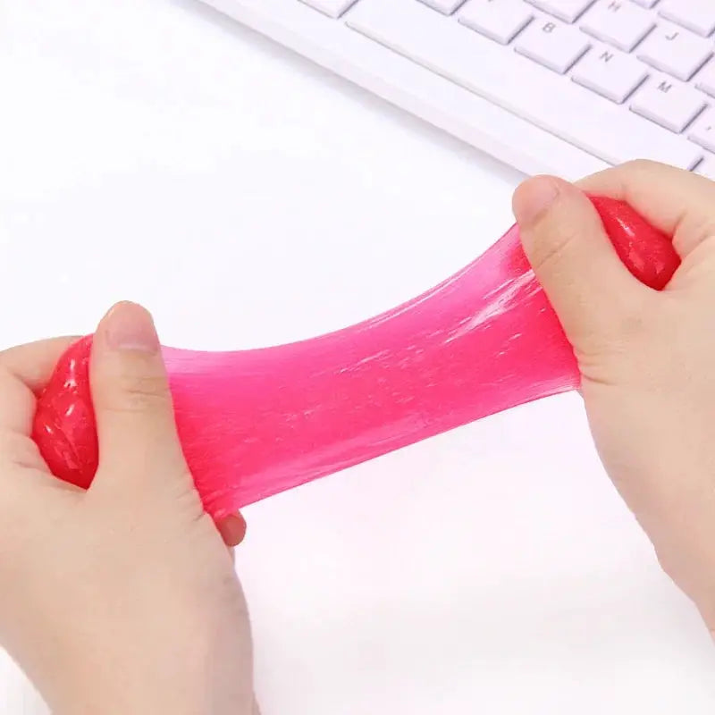 Car cleaning gel putty in pink being stretched between hands, a universal dust cleaner for automotive vents