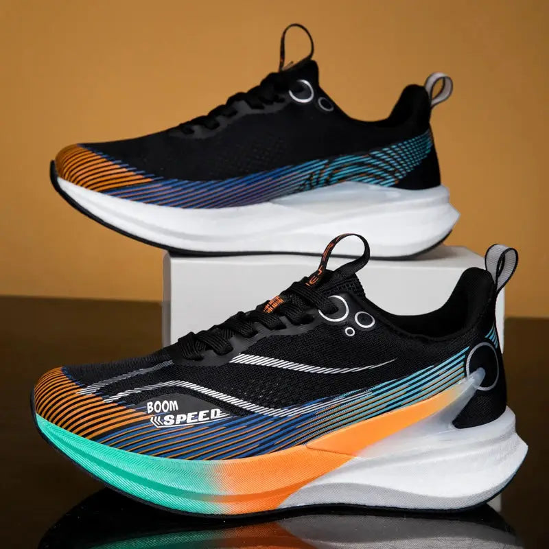 Pair of 2025 carbon board marathon running shoes, black with orange-teal gradient midsole, BOOM SPEED label