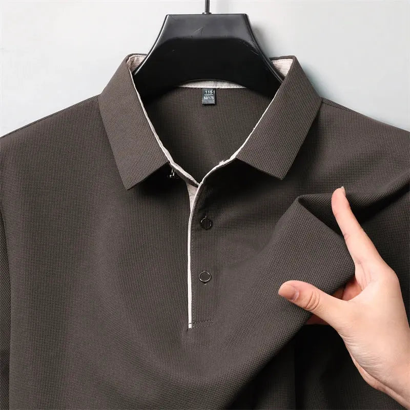 Long-sleeve brown polo shirt with white piping along the two-button placket and textured knit.