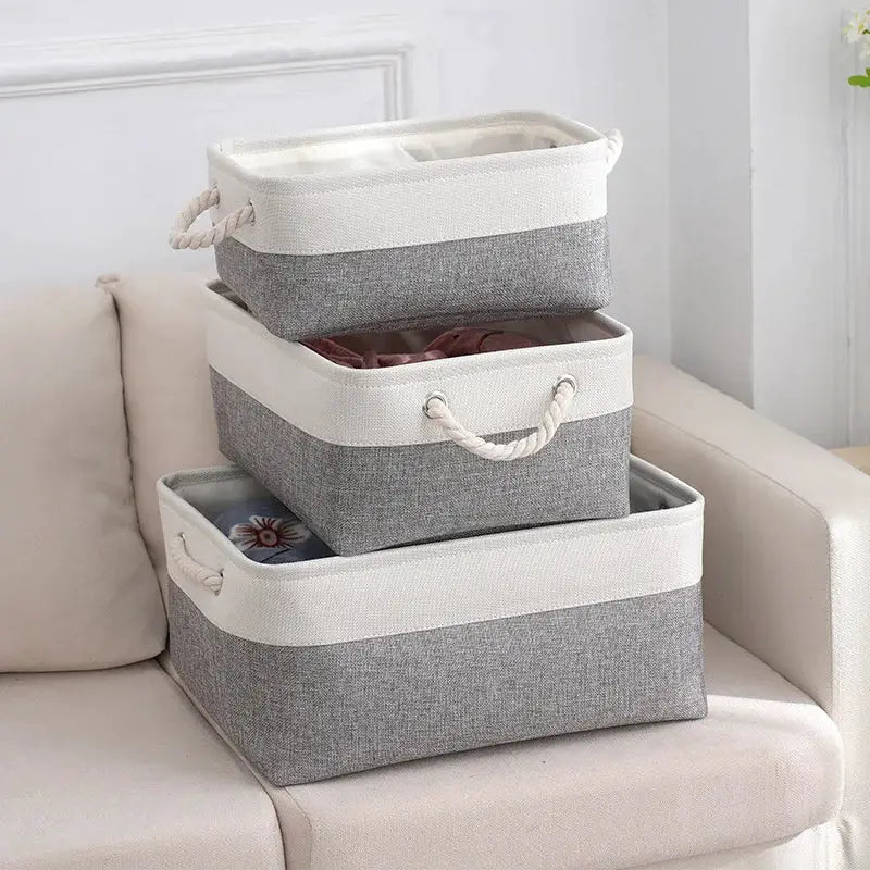 Linen fabric storage baskets with gray body and white trim, rope handles; foldable set of 3