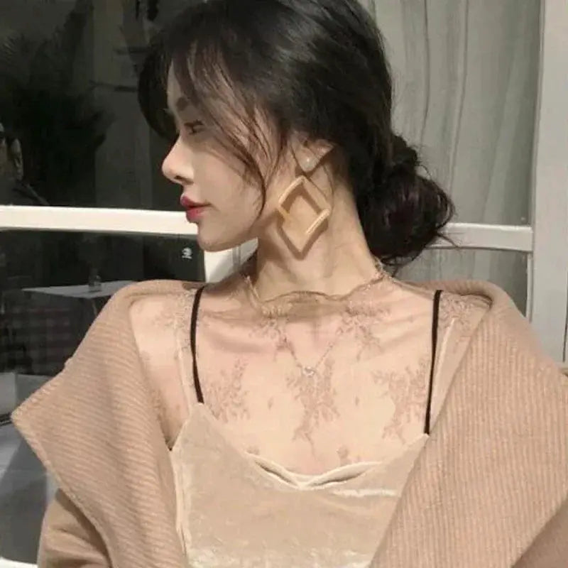 Beige sheer mesh lace blouse with long sleeves; see-through top with floral lace pattern.