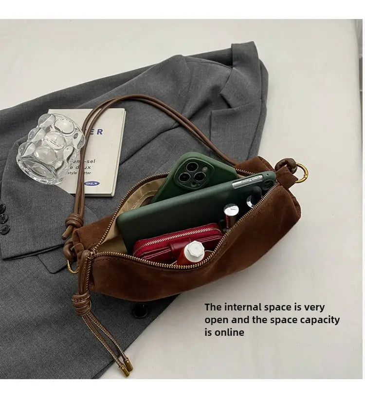 Brown faux suede shoulder bag by Simples Market; crossbody with zipper, opened to reveal phone and wallet inside