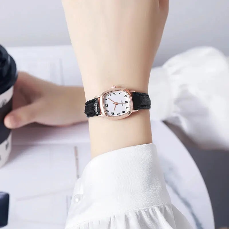 Women's watch with black leather strap, rose-gold case, white dial with Arabic numerals