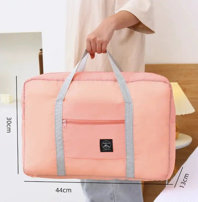 Large-capacity pink travel bag with light gray handles, Simples Market unisex weekend carry-on.
