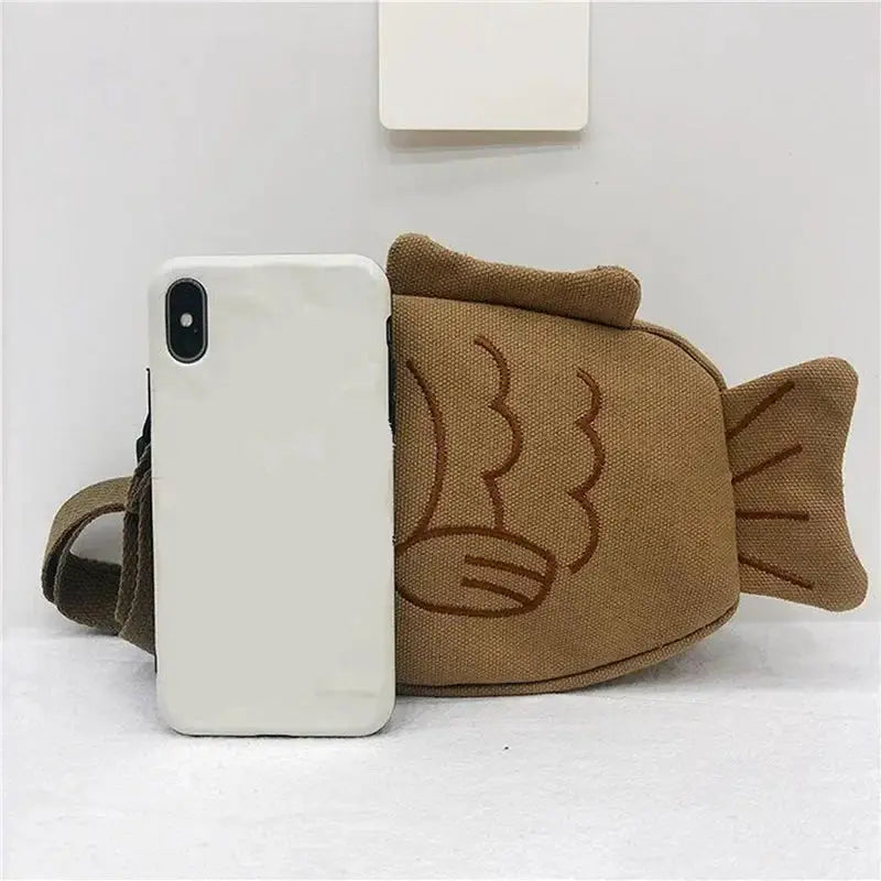 Fish-shaped brown canvas crossbody bag with embroidered details and zipper