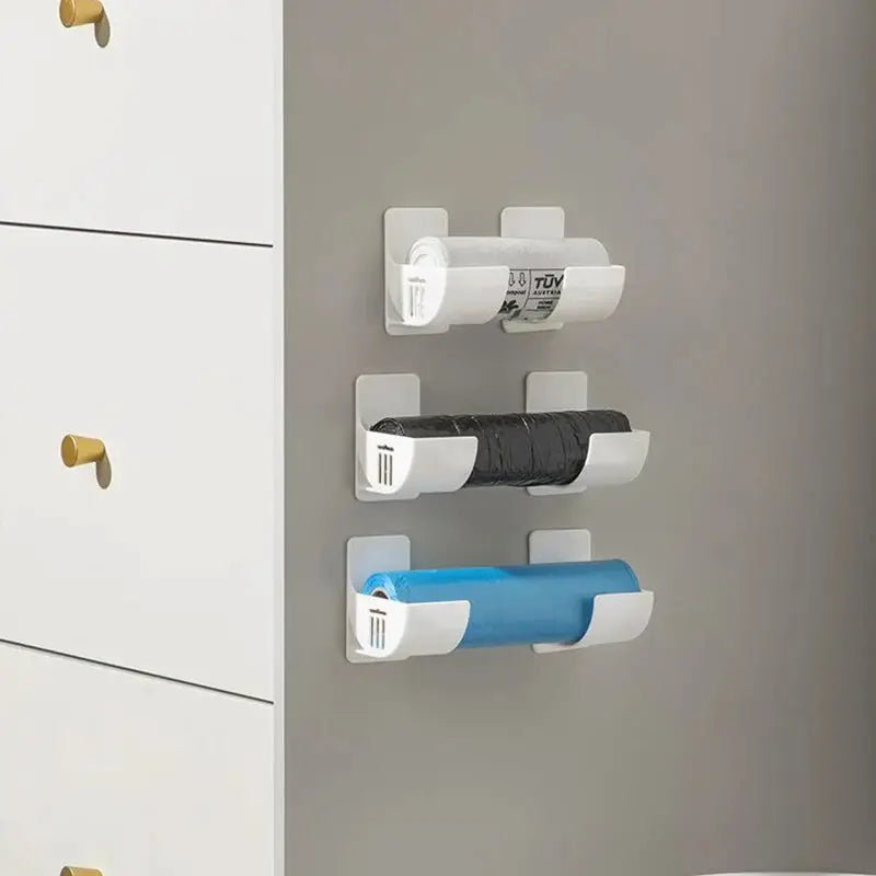 3 white wall-mounted storage racks for plastic wrap and garbage bags