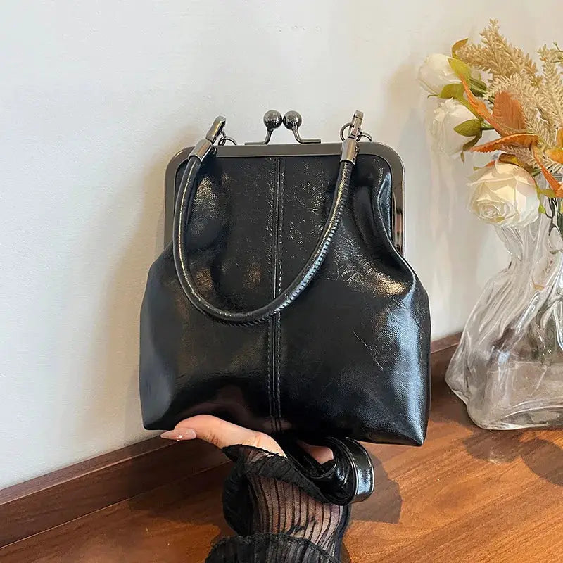 Black PU leather handbag with vintage metal frame, top clasp and shoulder straps
