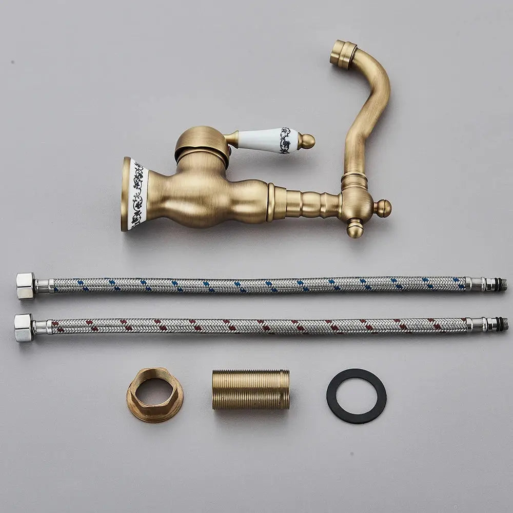 Antique brass bathroom faucet by Simples Market with rotating spout; includes two braided supply hoses and fittings