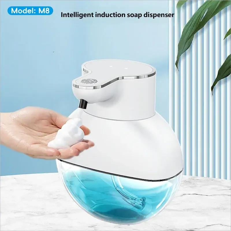 Homefish automatic soap dispenser, white body with clear blue liquid reservoir, wall-mounted.