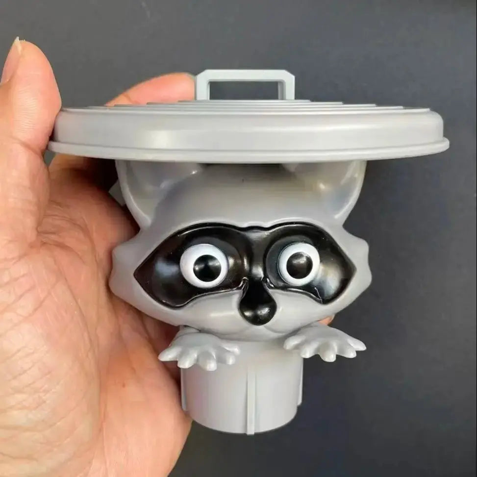 Toilet paper holder featuring a gray raccoon character by Simples Market; playful bathroom decor accessory.