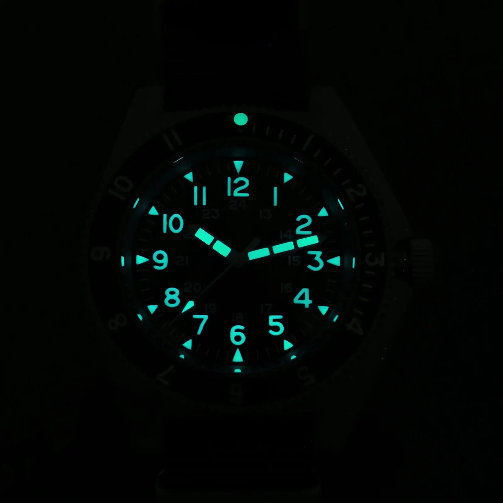 Watchdives WD1972 quartz diver watch dial with teal luminous numerals and markers in the dark