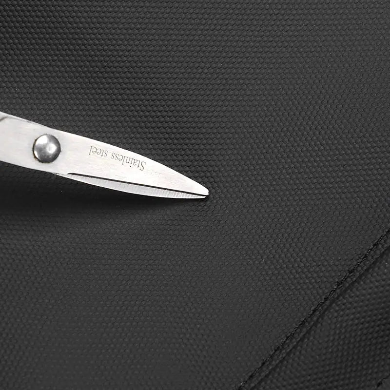 Backpack by Simples Market; black textured fabric close-up with stainless steel scissors for scale