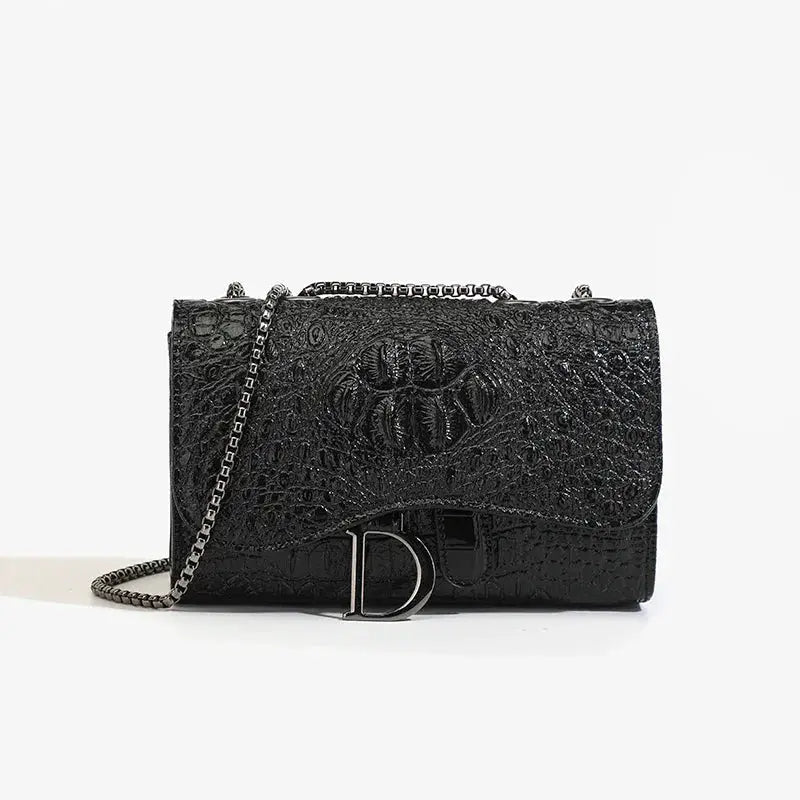 Women's luxury crossbody bag in black crocodile-embossed leather with silver chain strap and D-logo buckle.