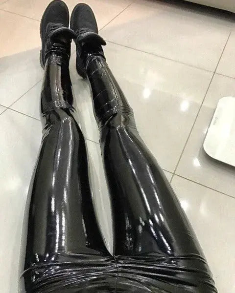 Women’s black PU leather-look pants, slim-fit leggings with a glossy finish, shown on legs.