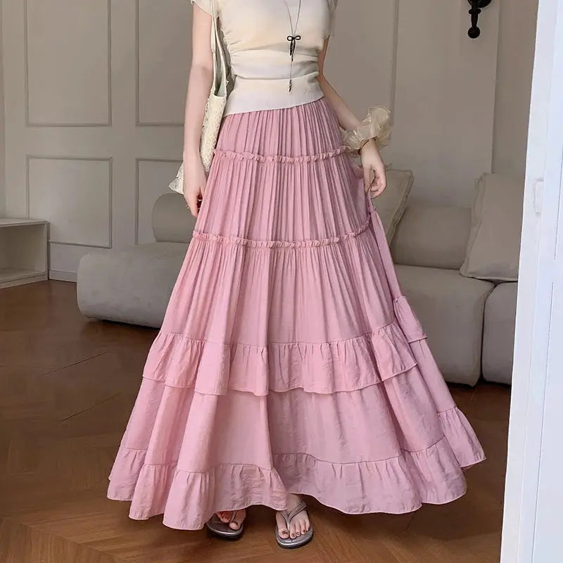 Tiered ruffle-hem maxi skirt in pink with high-waist, flowing chiffon layers.