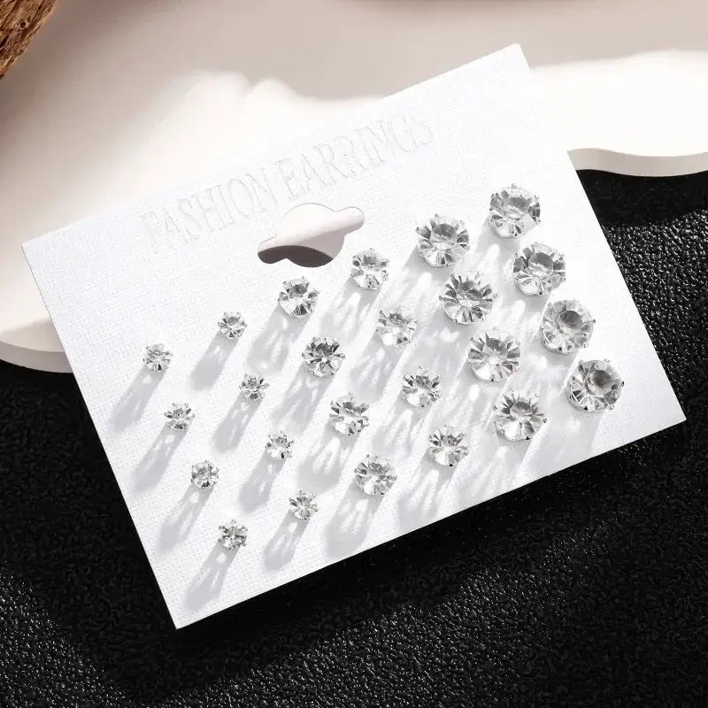 Crystal stud earrings set, 12 pairs, clear rhinestones on a white display card for women and men