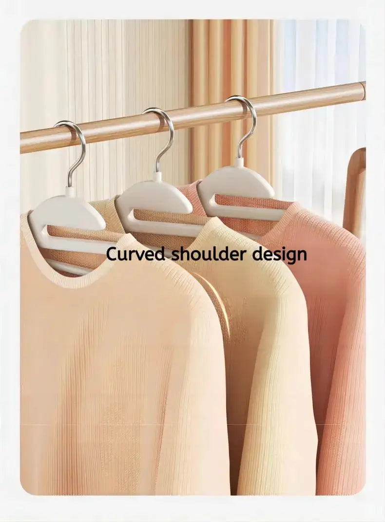 10-piece white curved-shoulder clothes hangers on a rod; three hangers visible.