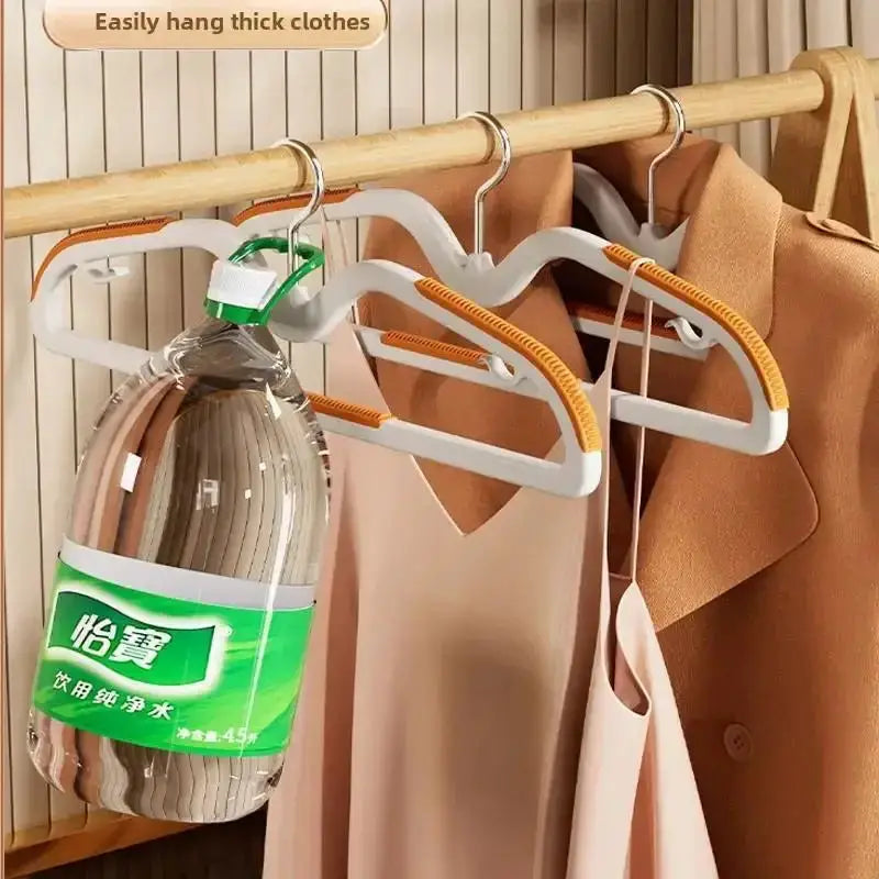 Set of 3 short-neck non-slip clothes hangers on a wooden rod; white with orange grips for space-saving storage
