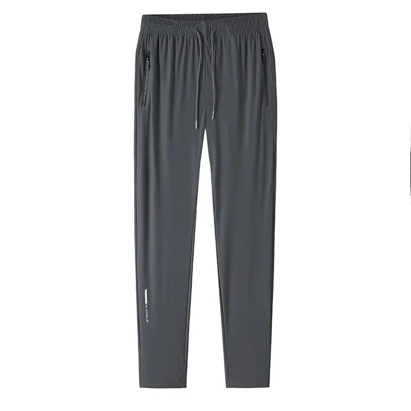 Men's ice silk pants by Simples Market in dark gray with elastic waistband and zip pockets.
