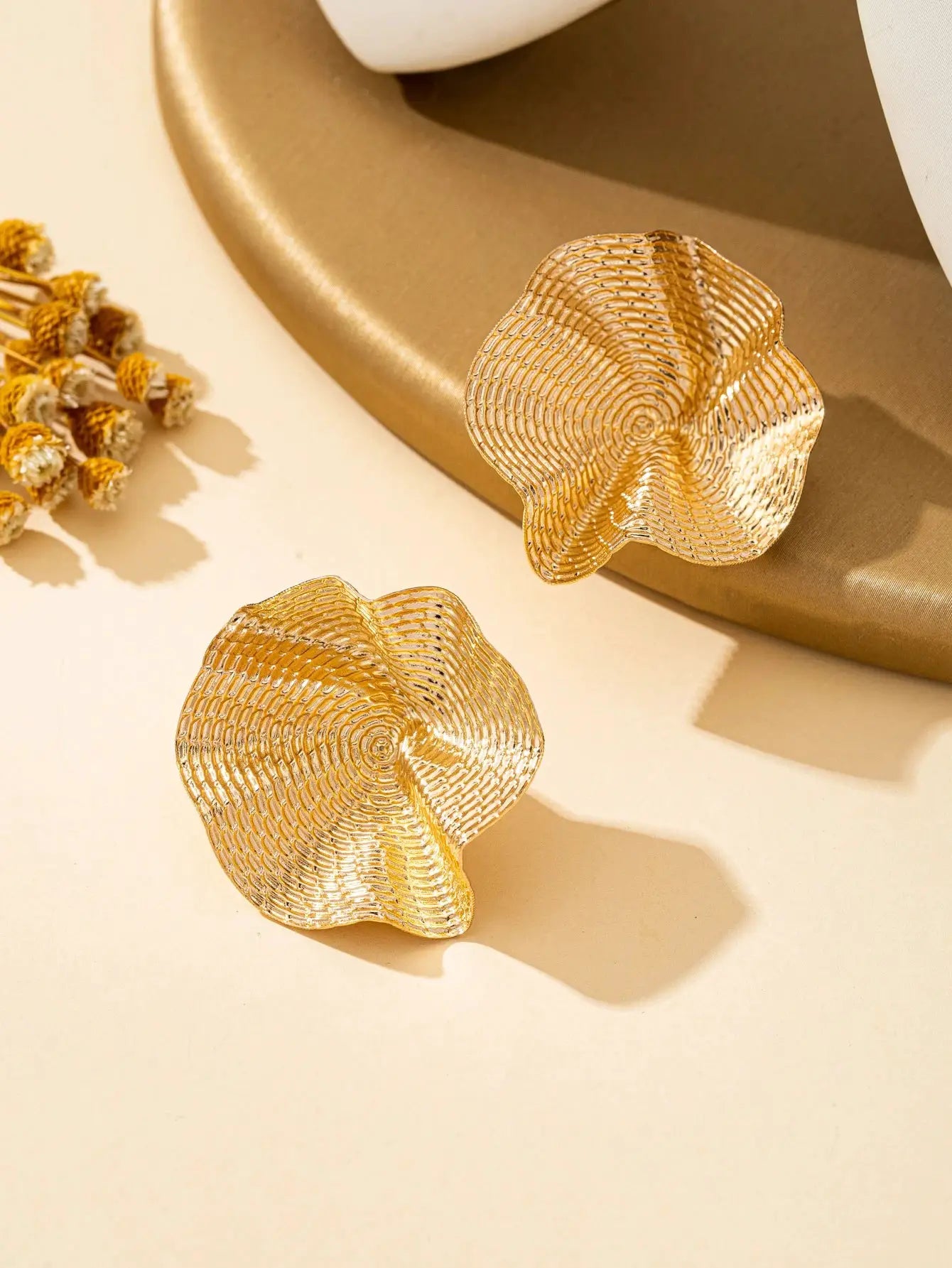 Gold-tone irregular round metal stud earrings with textured shell design, set of 3