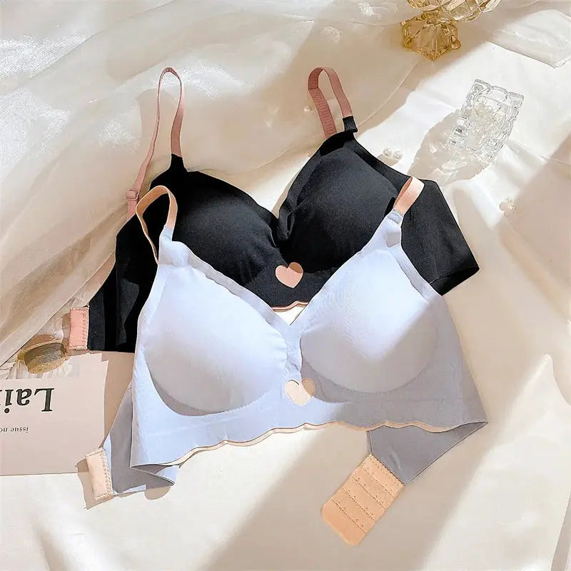Two Simples Market push-up bras in black and light blue with pink straps and heart accents, wireless seamless lingerie