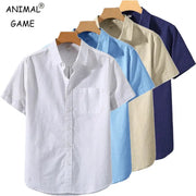 Five men's short-sleeve solid-color cotton shirts in white, light blue, blue, beige, and navy on wooden hangers.