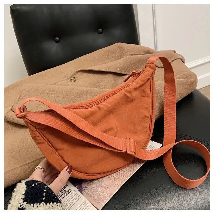 Casual nylon hobo crossbody bag for women in orange; large-capacity travel shopper.