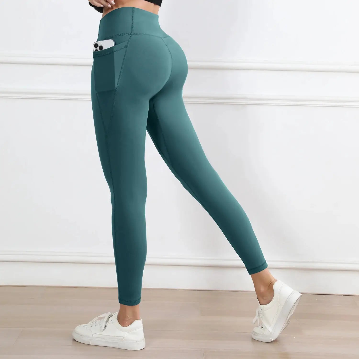 Women's teal high-waist leggings with pockets; butt-lifting workout tights.