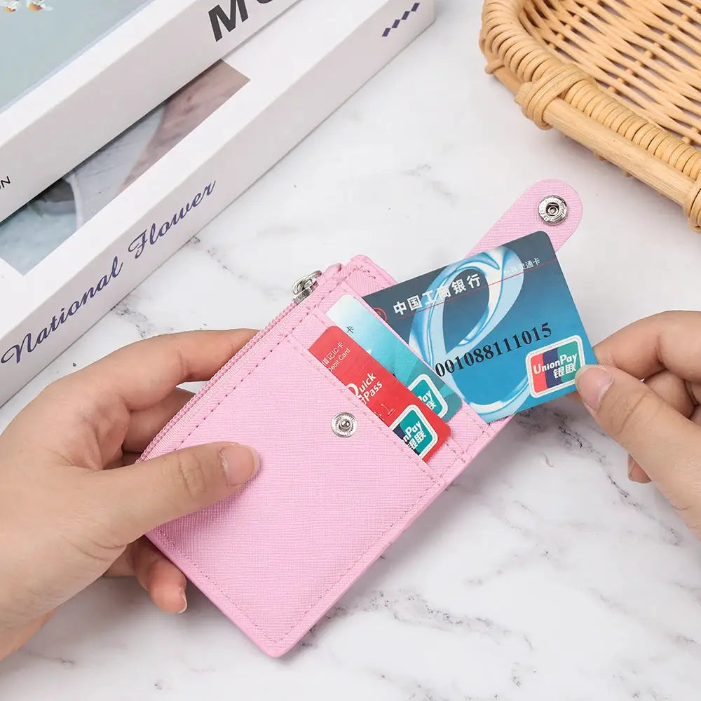 Pink PU leather mini wallet with card slots, zipper pocket and front snap closure.