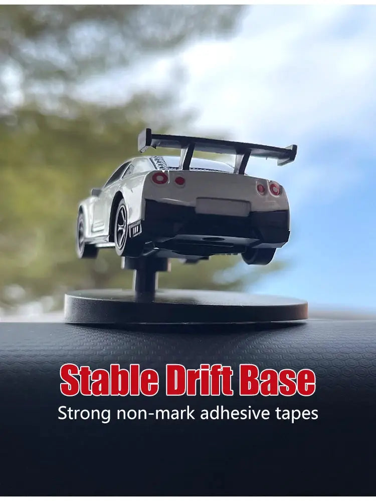 Dr drift car dashboard toy model on display stand; white sports car with rear spoiler.