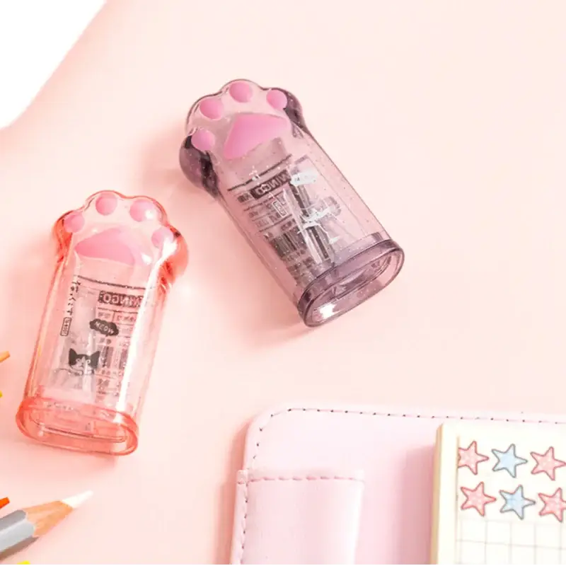 Kawaii cat paw pencil sharpeners in pink and purple translucent plastic, Simples Market, 2 pcs