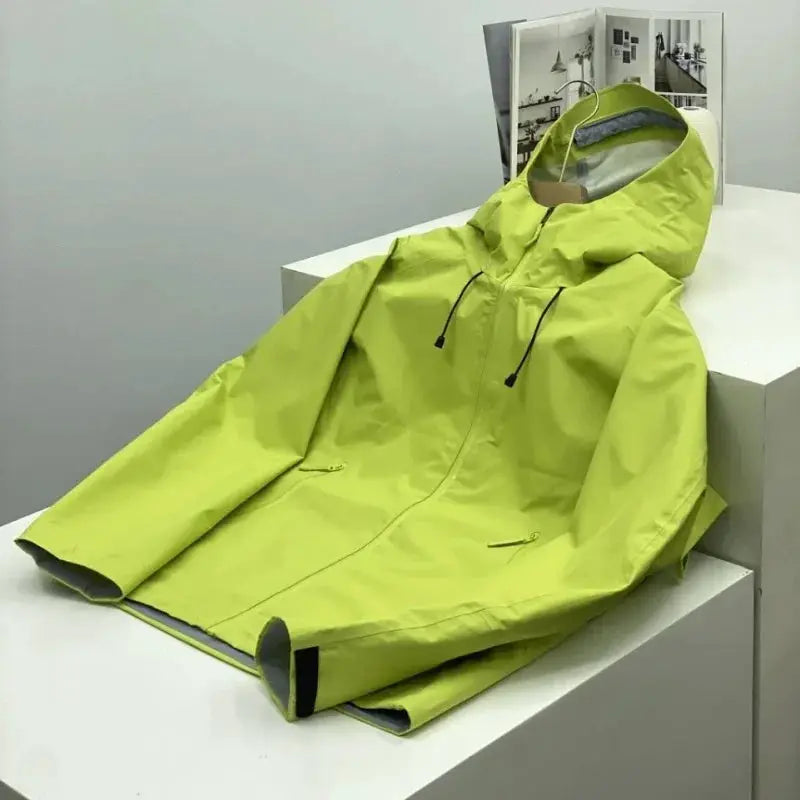 Simples Market men's windproof soft-shell outdoors jacket in neon lime green with hood, on display.