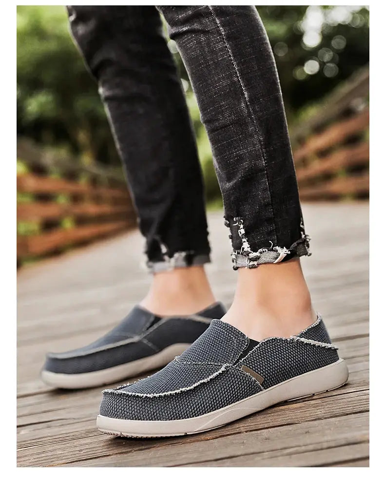 Men's lightweight canvas slip-on loafers in dark blue with white sole, frayed edge detail