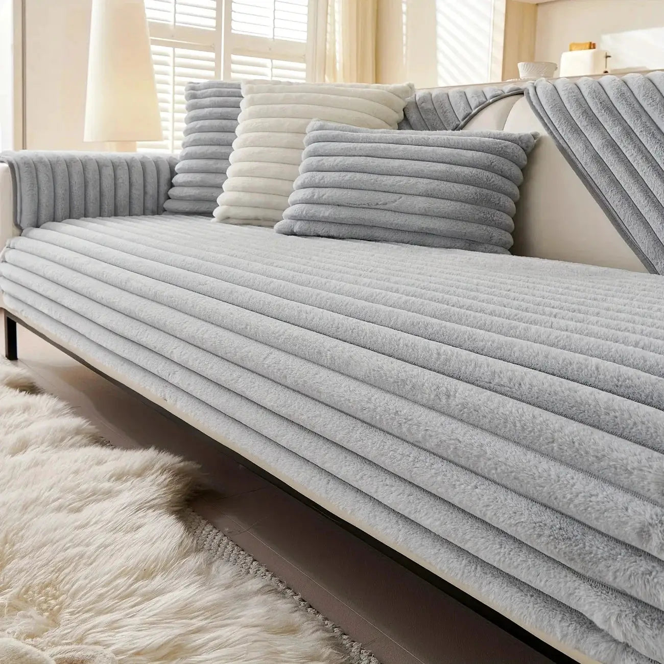 Simples Market thicken plush stripe imitation rabbit fur non-slip sofa cover in gray on a couch