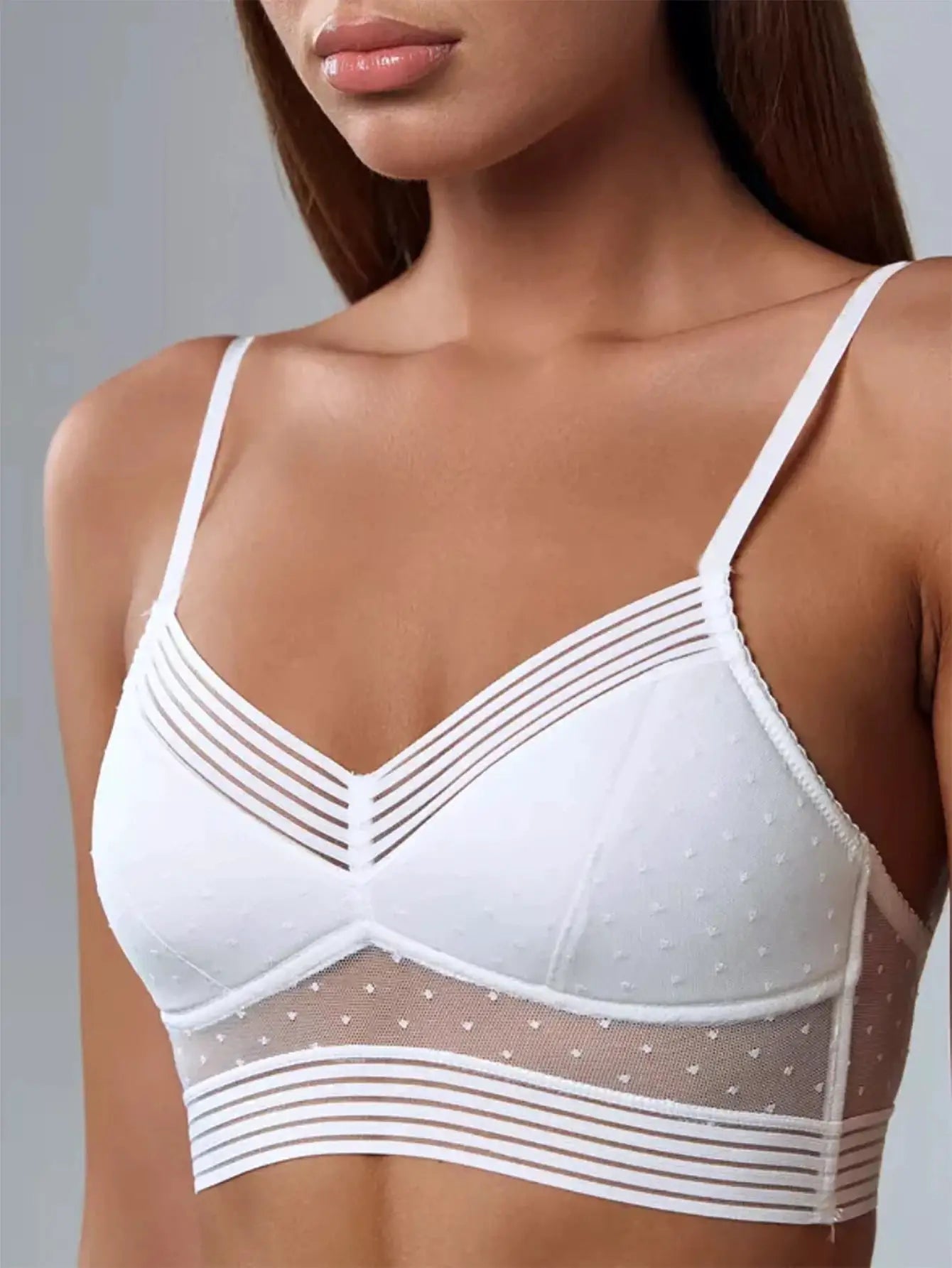 White lace bralette with dotted mesh and thin horizontal striped bands across the cups.