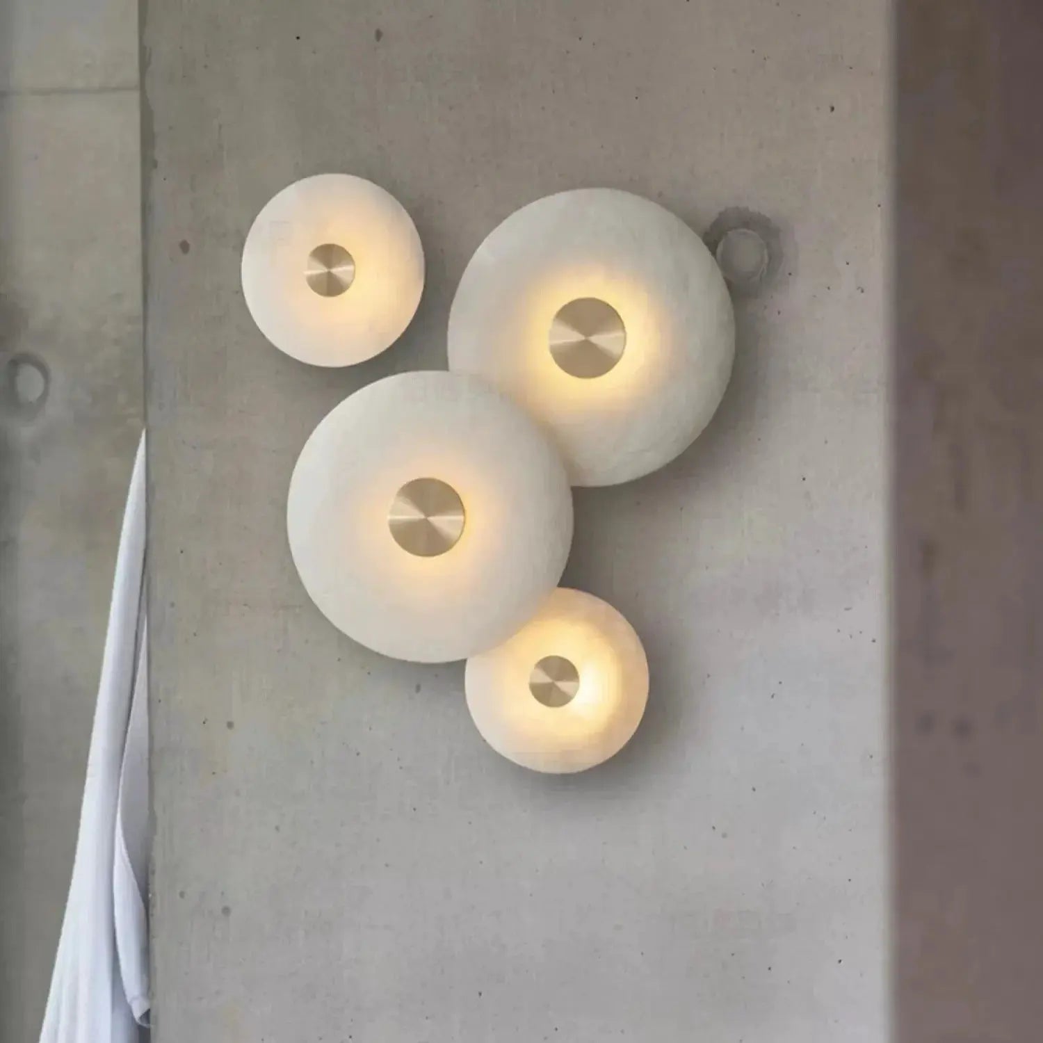 Set of five round Spanish natural marble wall lamps with copper centers and warm LED glow