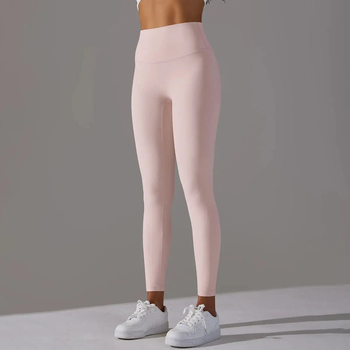 High-waist pale pink leggings for women, fitness/yoga, ankle-length with white sneakers
