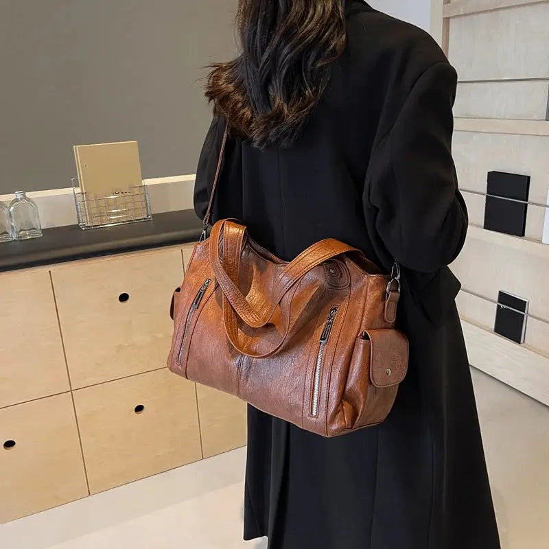 Brown PU leather shoulder bag with top handles and multiple exterior zip pockets