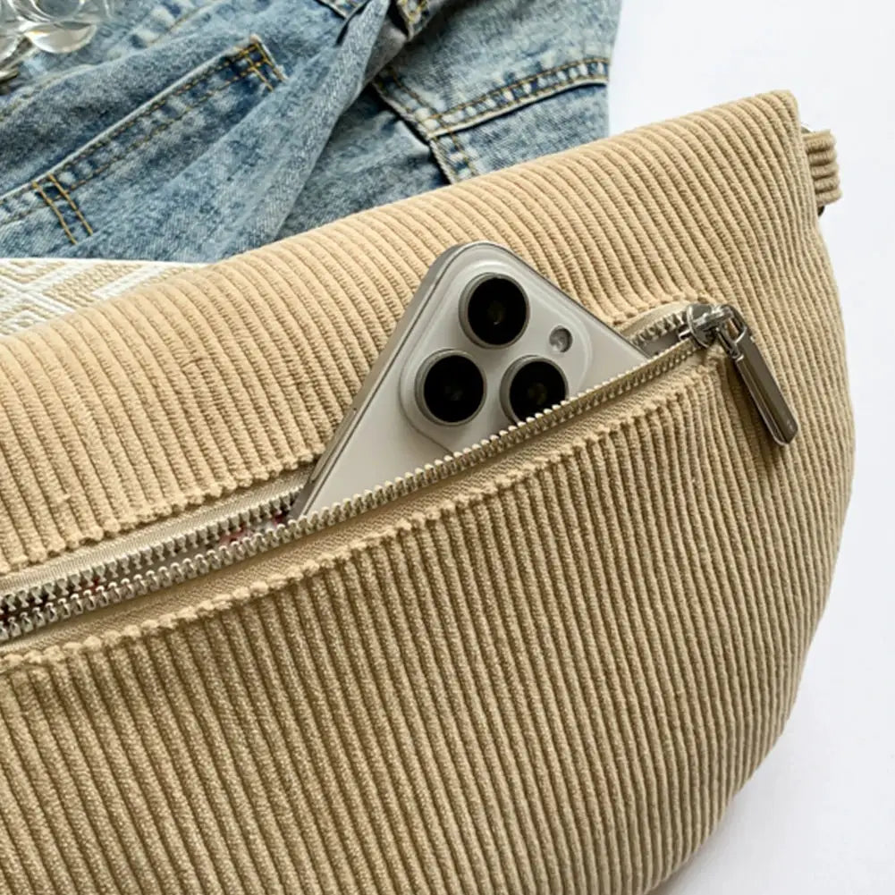 Beige corduroy chest bag with zip pocket; smartphone visible in front pocket
