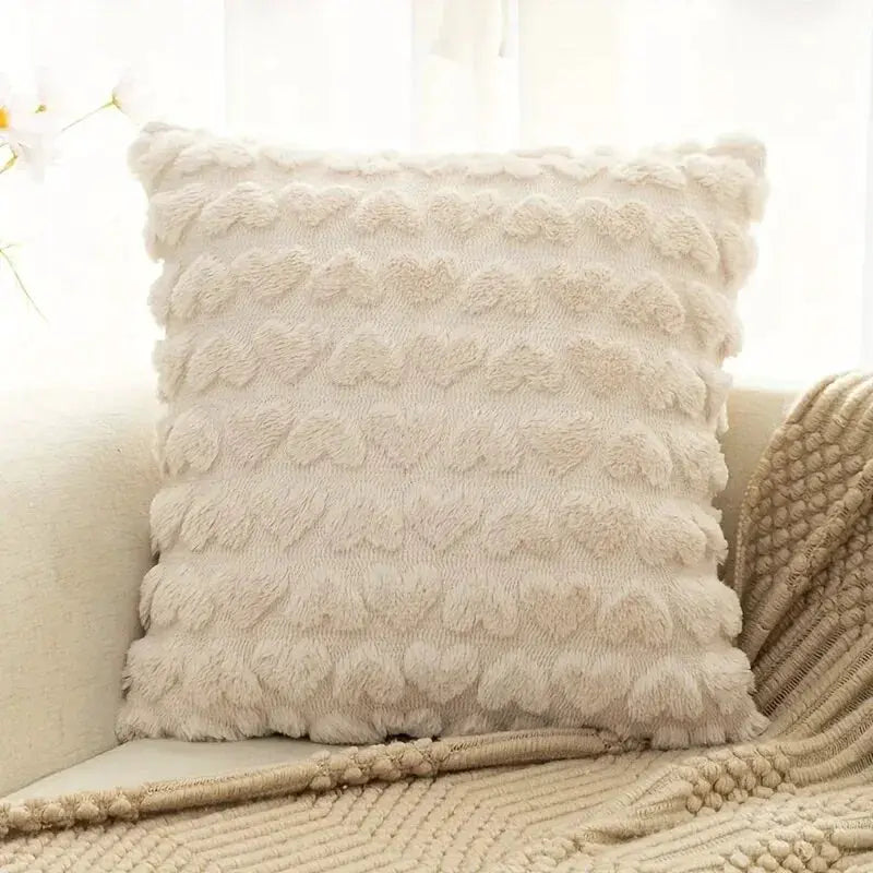 Modern solid color love plush throw pillow cover in ivory with textured faux fur on a beige sofa