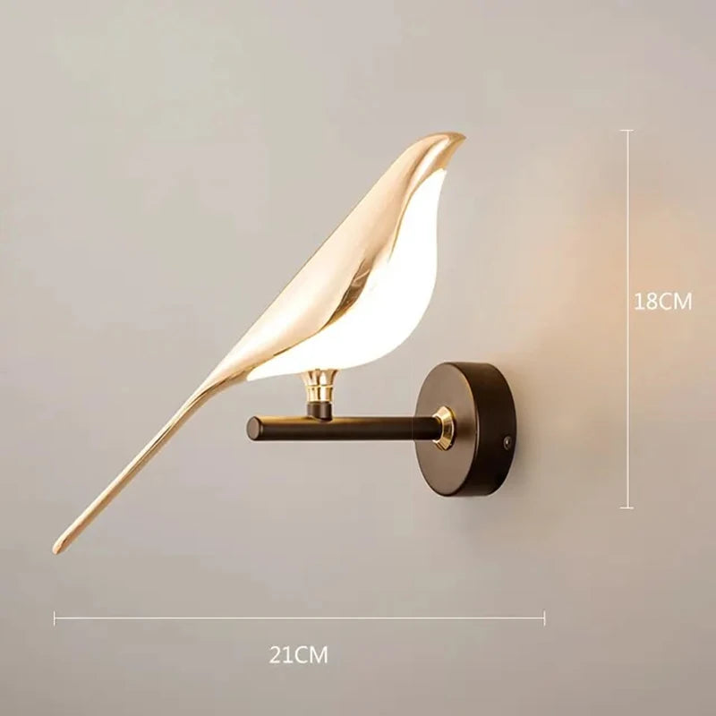 Modern LED wall lamp with a gold and white magpie bird design on a dark bronze wall mount