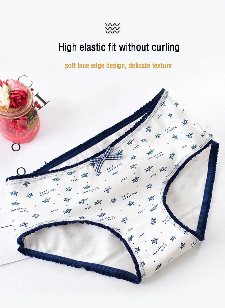 Women’s cotton seamless underwear in white with navy lace-edge trim, bow detail and star print.