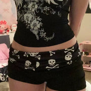 Skull-print shorts by Simples Market, black with white skull graphics, low-waist women’s streetwear
