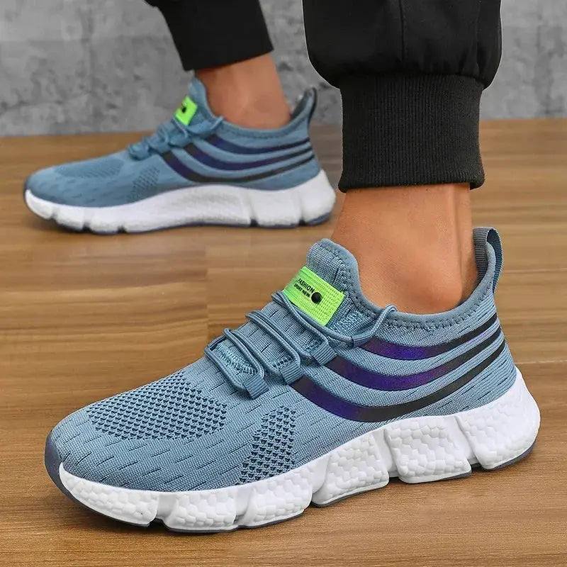 Pair of Simples Market men's sneakers, blue breathable knit upper with purple side stripes and white platform sole.