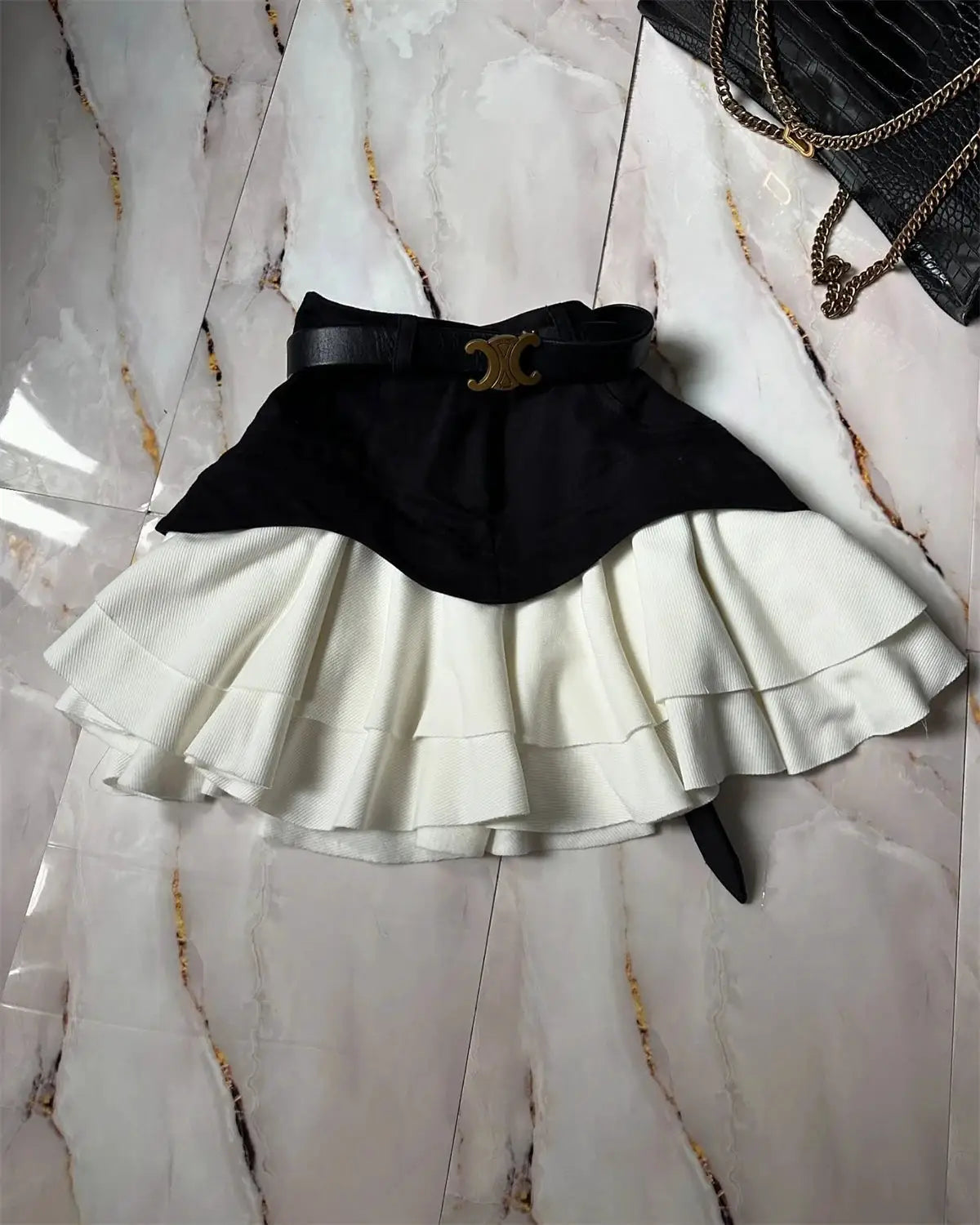 Chic ruffle-tiered women's midi skirt with black high-waisted belt and white layered hem