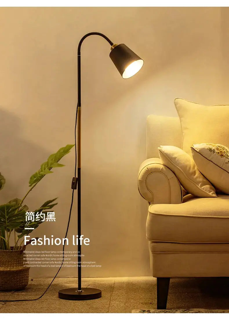 Floor lamp with black wrought iron stand and adjustable LED head beside a sofa in a living room