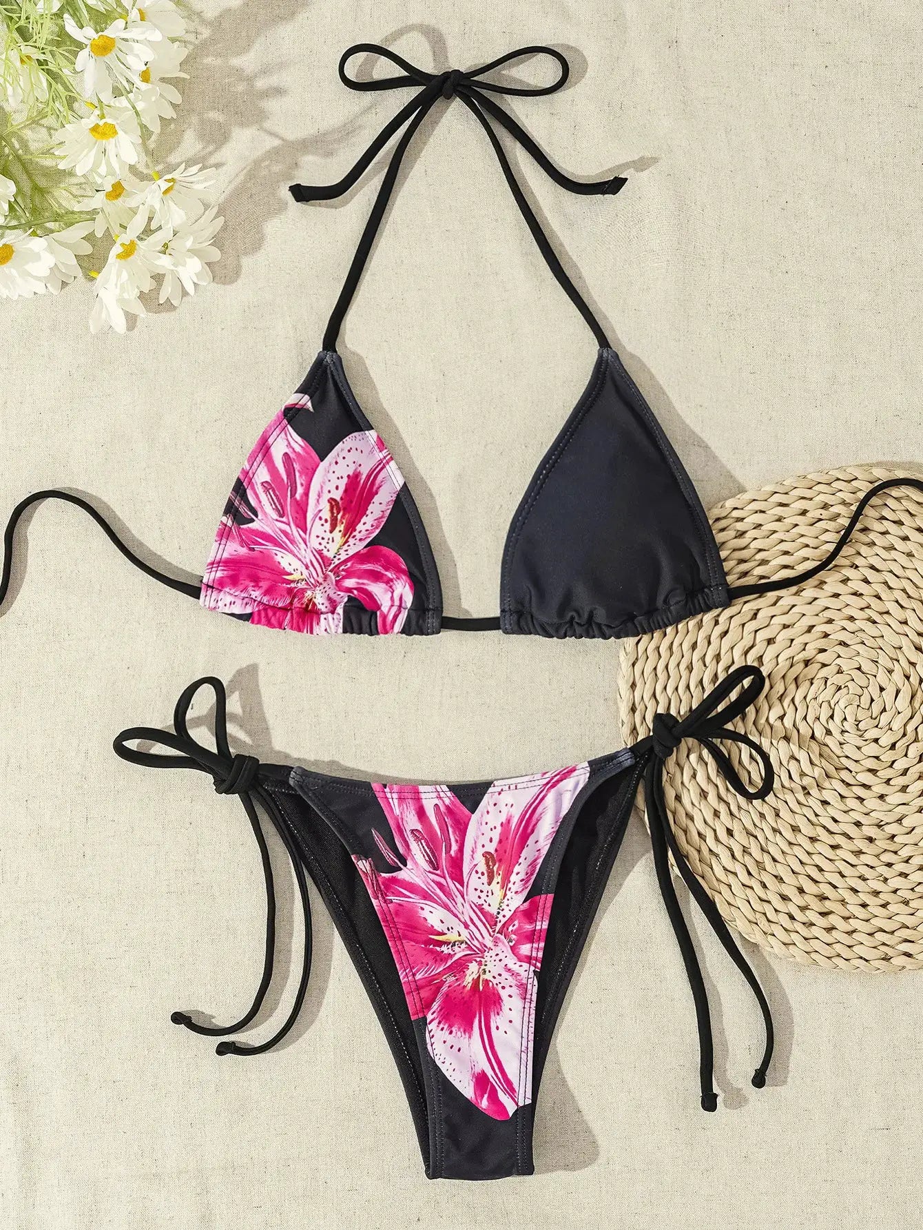 Bikini set with halter top and tie-side bottoms; black panels with pink tropical floral print