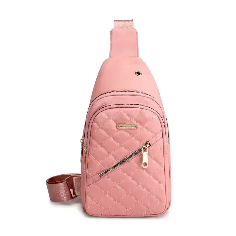 Pink quilted shoulder bag by Simples Market with diagonal zipper pocket