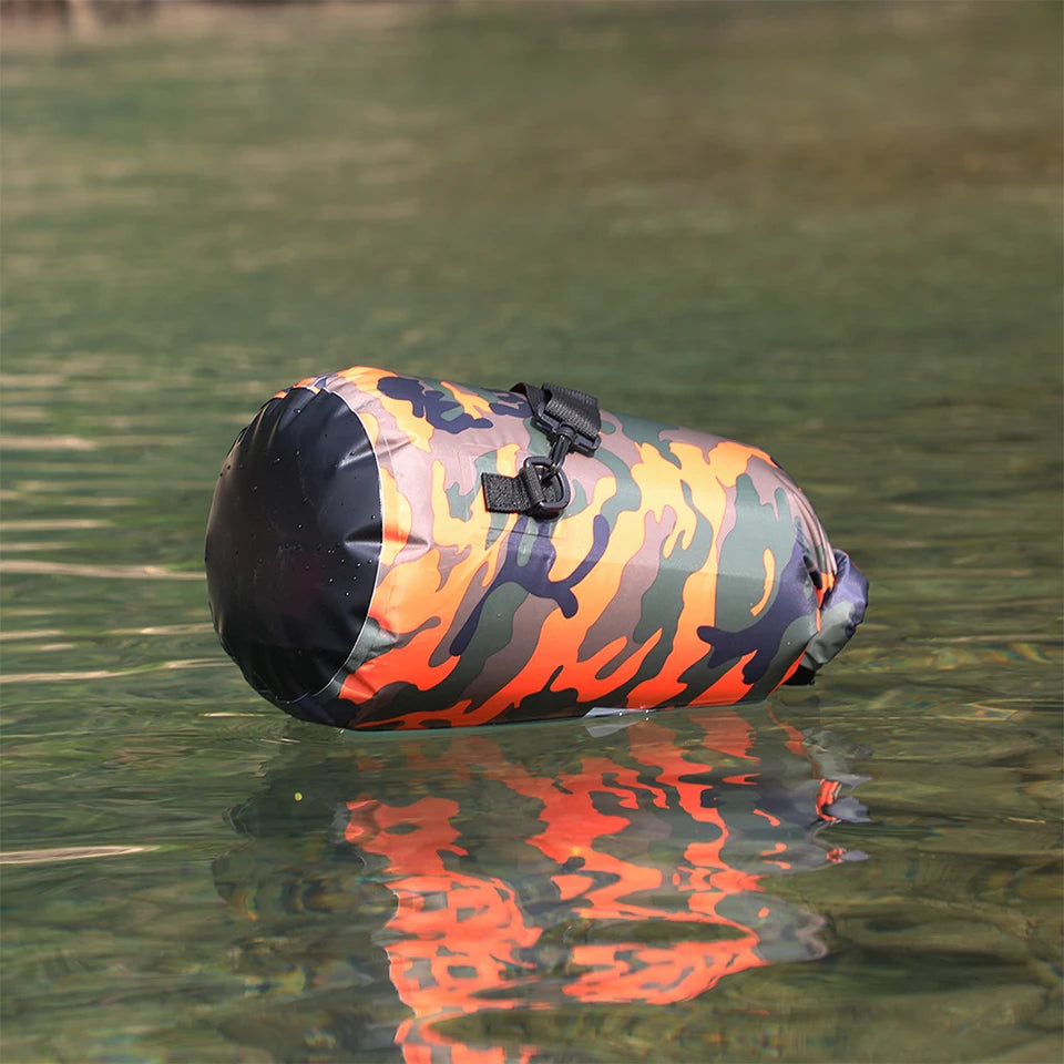 Dry bag waterproof in orange camo pattern with black ends, floating on water