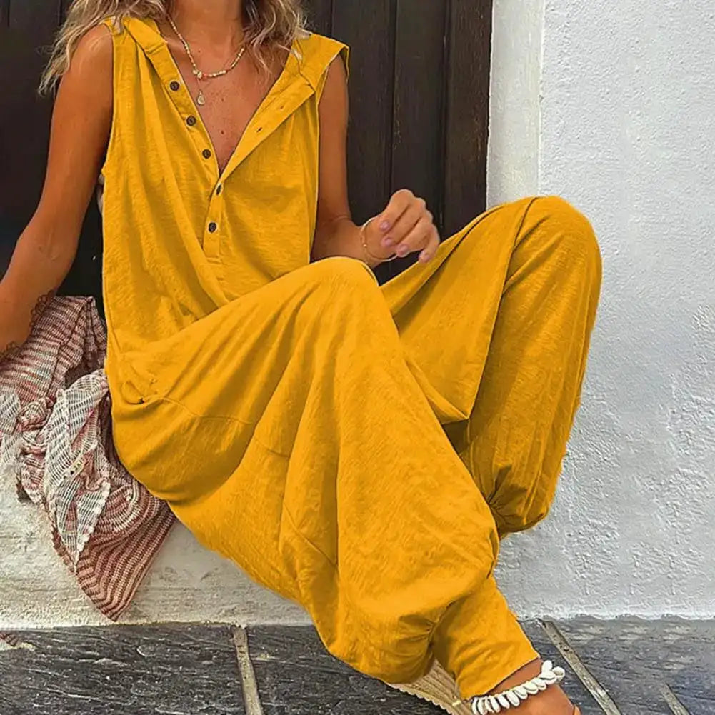 Mustard yellow cotton women's overalls with button-front placket and wide-leg silhouette.